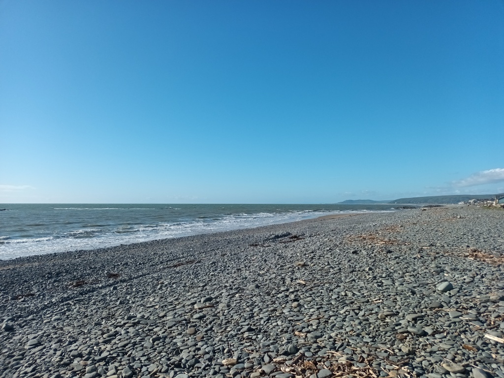 A view of borth beach, which is covered in grey stones 